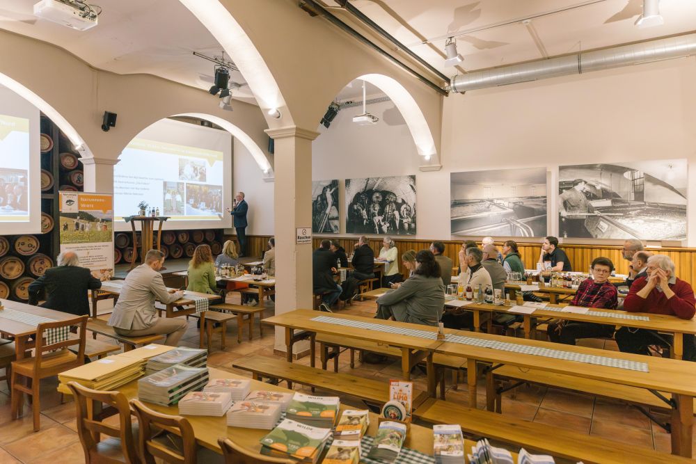 Naturpark-Wirte sitzen im Veranstaltungsraum bei Alpirsbacher Klosterbräu
