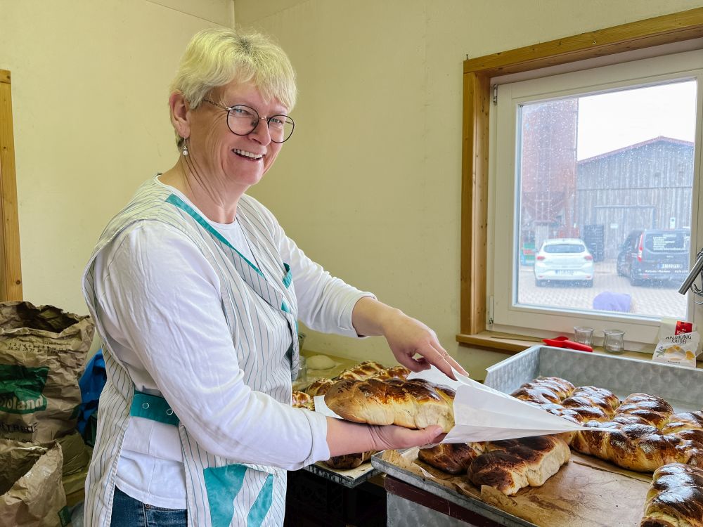 Elke Reiser packt einen Hefezopf in eine Papiertüte.