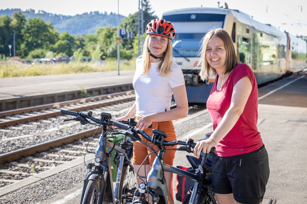 Zwei Radfahrerinnen am Bahnsteig